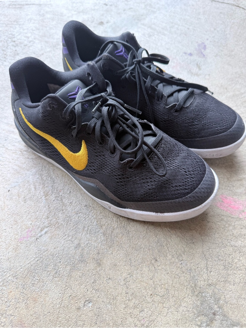 Nike Black Athletic Shoes with Gold Swoosh and Purple Accents